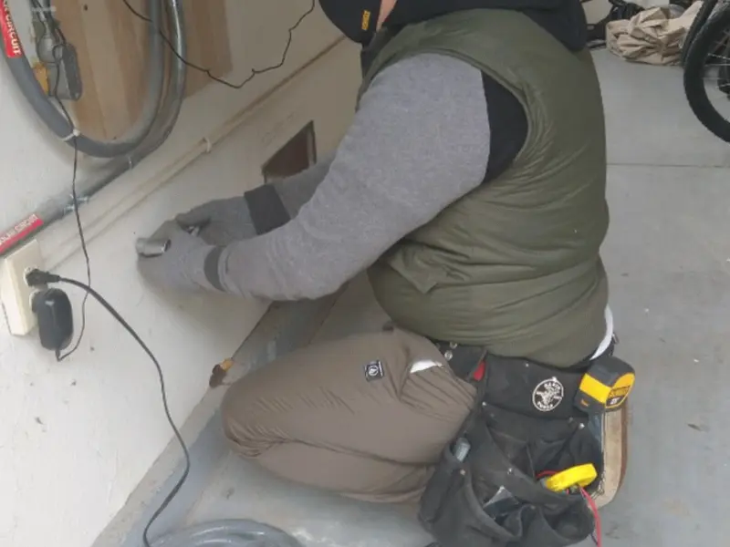 Electrician performing outlet wiring in a Mount Gilead garage